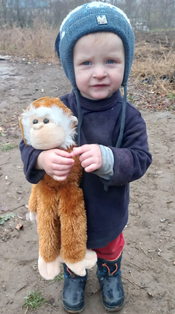 Grigore and his stuffed monkey, one of his favorite toys