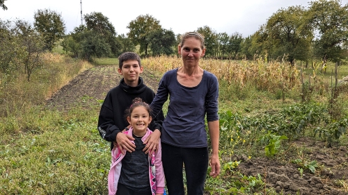 Alin with his mother and sister at home in Romania