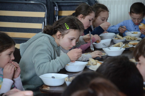 Claudia and other students enjoy a hot meal at MWB's After School Club