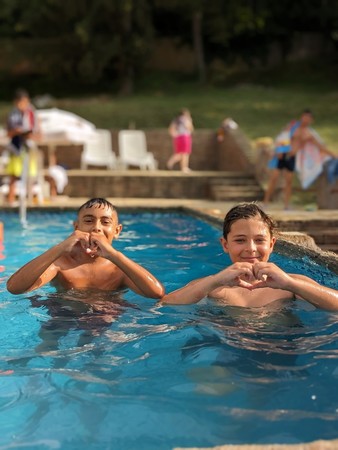 Having the opportunity to swim ina pool and play with friends at summer camp