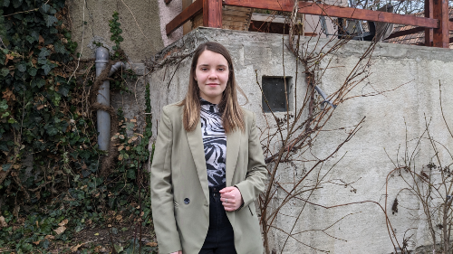 Melisa outside her home in Romania